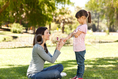 Joyful mother with her daughter in the park