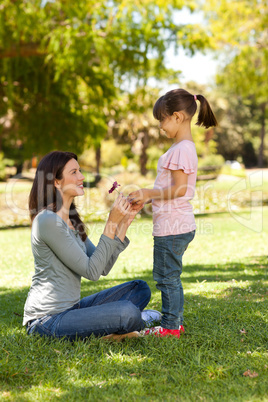 Joyful mother with her daughter in the park