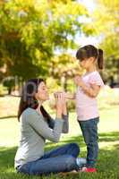 Beautiful mother with her daughter in the park