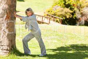 Mature woman doing her streches in the park