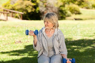 Retired woman doing her exercises in the park