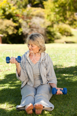 Retired woman doing her exercises in the park