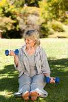 Retired woman doing her exercises in the park