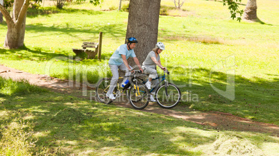 Retired couple mountain biking outside