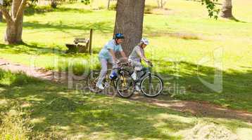Retired couple mountain biking outside
