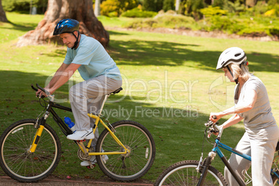 Retired couple mountain biking outside