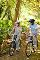 Elderly couple mountain biking outside