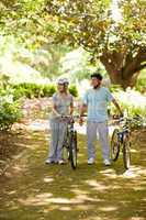 Couple with their bikes in the wood