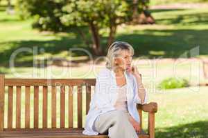 Senior woman thinking on the bench