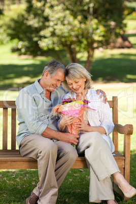 Mature man offering flowers to his wife