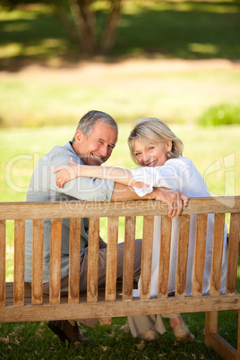 Happy retired couple sitting on the bench