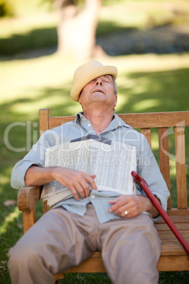 Senior man sleeping on the bench