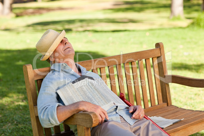 Senior man sleeping on the bench