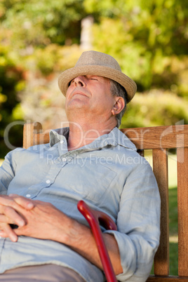 Senior man sleeping on the bench