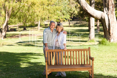 Portrait of a lovely couple behind the bench