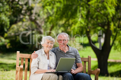 Elderly couple looking at their laptop