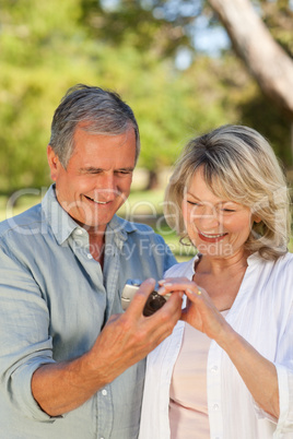 Mature couple looking at their camera