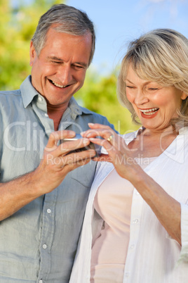 Mature couple looking at their camera