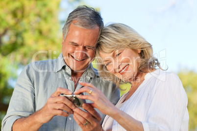 Mature couple looking at their camera