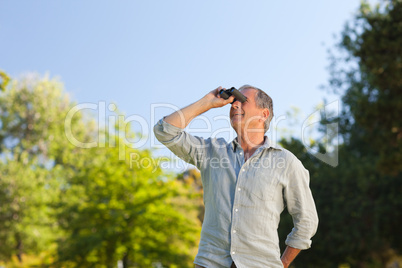 Man looking at the sky with his binoculars