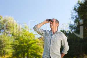 Man looking at the sky with his binoculars