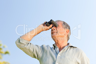 Man looking at the sky with his binoculars