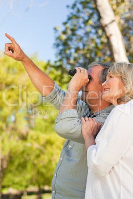 Couple looking at the sky with their binoculars