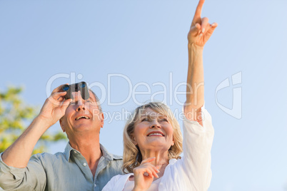 Couple looking at the sky with their binoculars