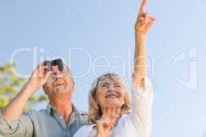 Couple looking at the sky with their binoculars