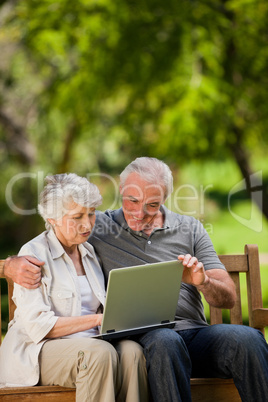 Elderly couple looking at their laptop