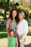 Smiling family looking at the camera in the park