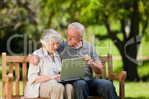 Elderly couple looking at their laptop