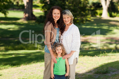 Smiling family looking at the camera in the park Smiling family looking at the camera in the park