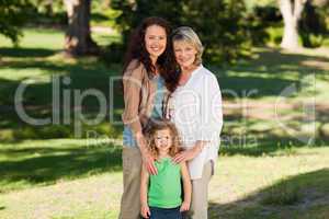 Smiling family looking at the camera in the park