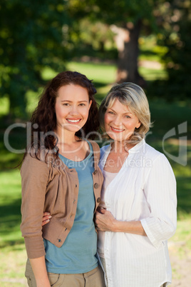 Mother with her daughter looking at the camera in the park