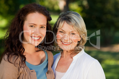 Mother with her daughter looking at the camera in the park