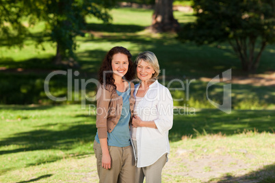 Mother with her daughter looking at the camera in the park