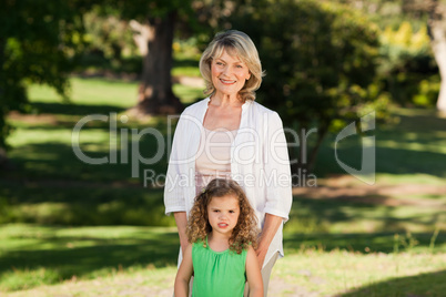 Grandmother with her granddaughter looking at the camera in the