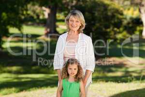 Grandmother with her granddaughter looking at the camera in the