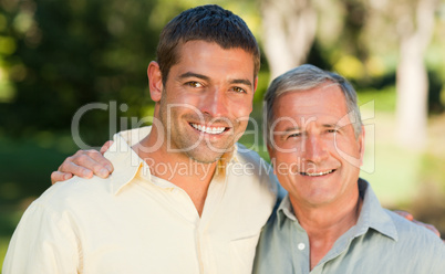 Father with his son looking at the camera in the park
