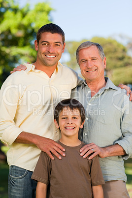 Radiant family looking at the camera in the park