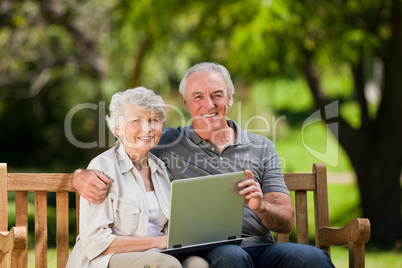 Elderly couple looking at their laptop