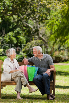 Retired couple with shopping bags