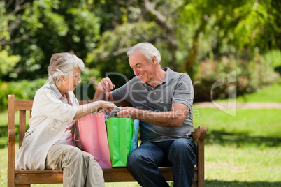 Retired couple with shopping bags