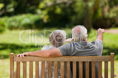 Couple sitting on the bench  with their back to the camera