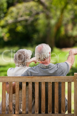 Couple sitting on the bench  with their back to the camera