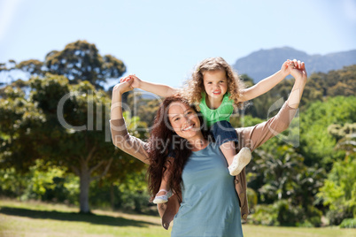 Woman giving daughter a piggyback