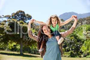 Woman giving daughter a piggyback