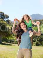 Woman giving daughter a piggyback