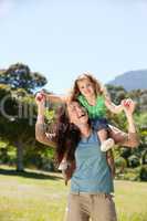 Woman giving daughter a piggyback